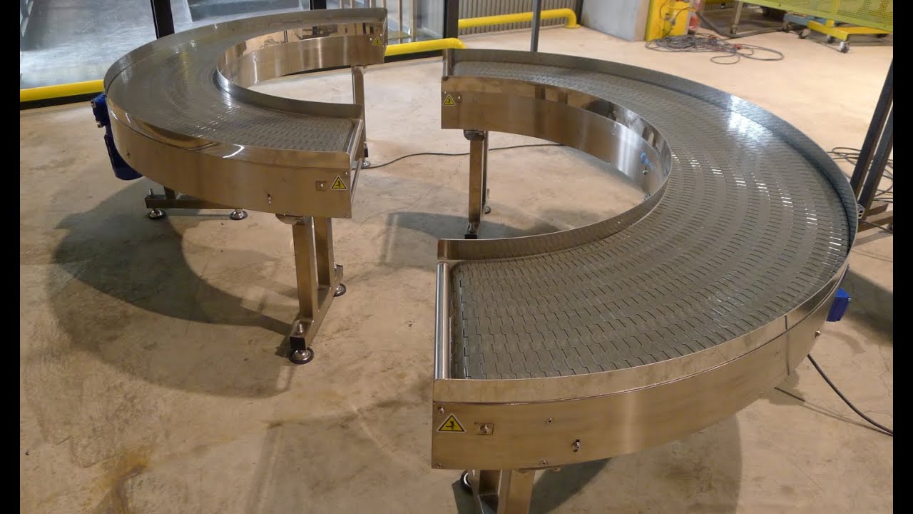 A stainless steel 180-degree curve conveyor on castors in the NEXUS factory.