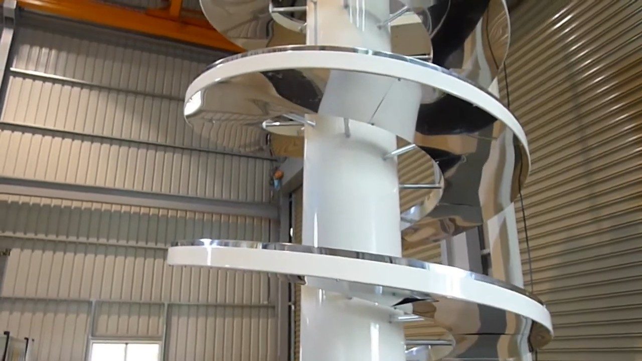 A spiral conveyor with white side guards seen from below.