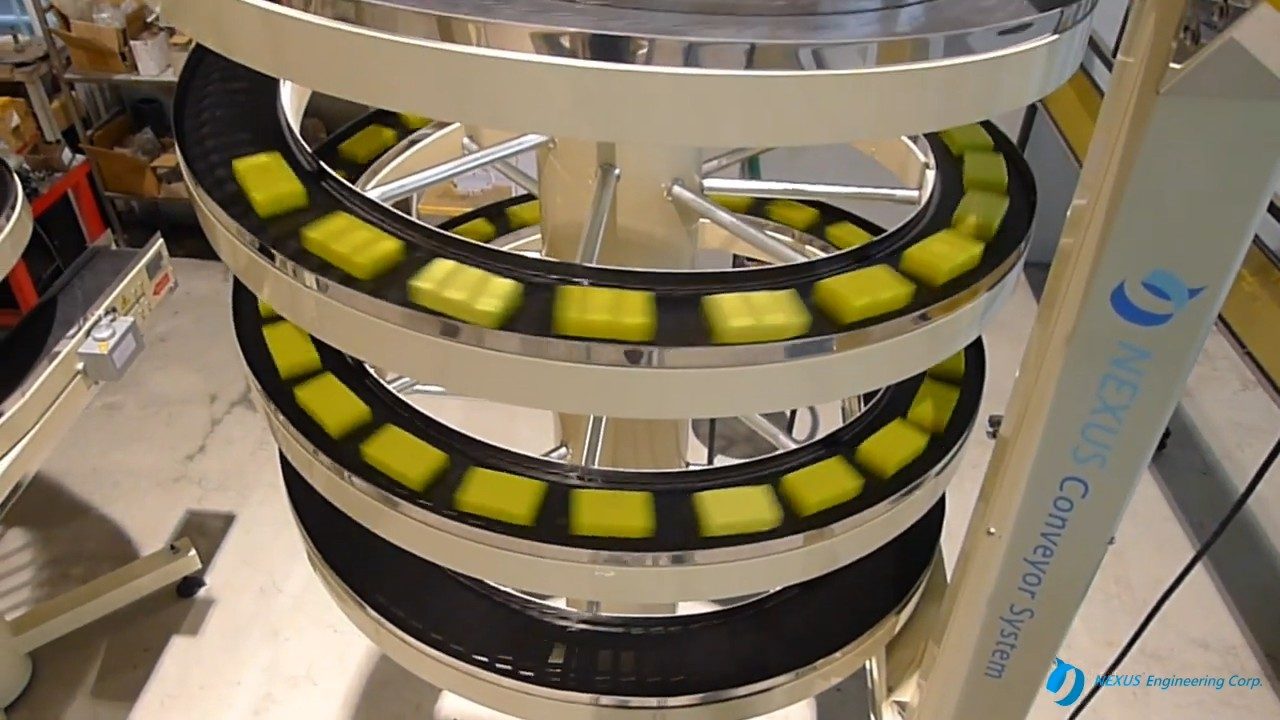Yellow soap bars on the tracks of a spiral conveyor in the NEXUS factory.